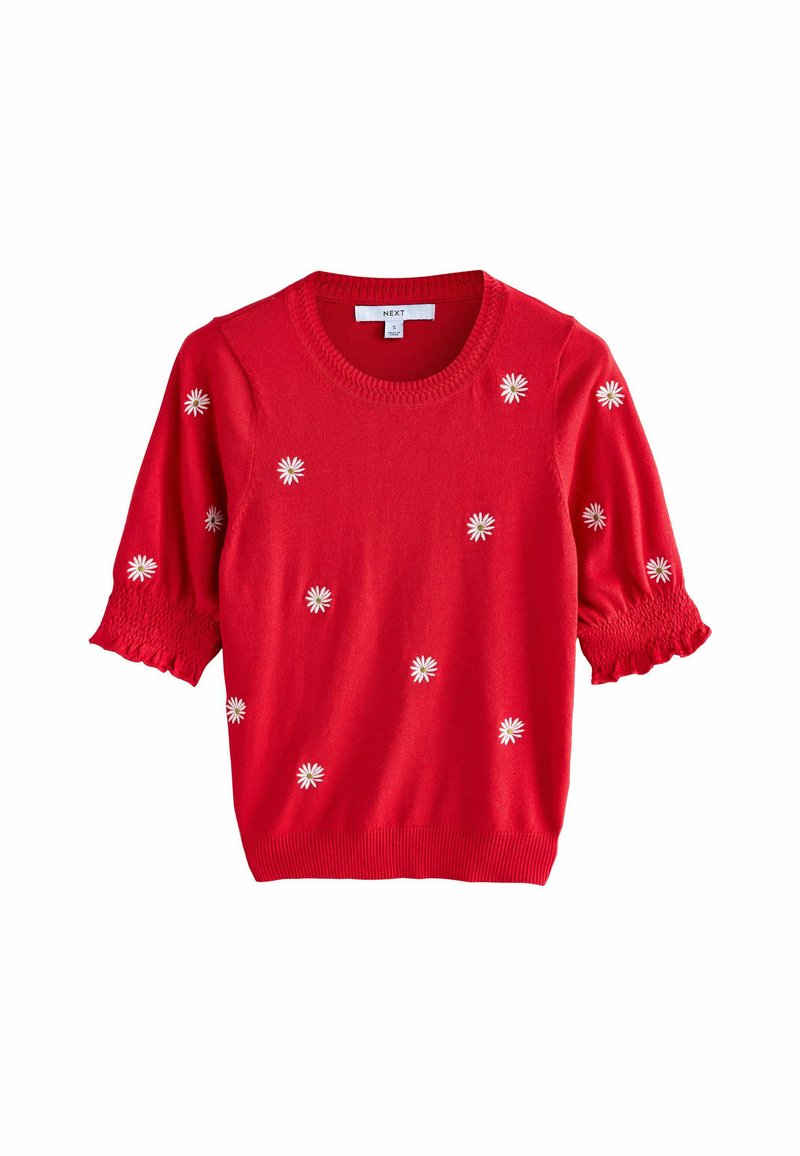Pull court en tricot rouge à manches courtes avec broderie de marguerite. Présente un col rond et des manches smockées. Texture lisse, coupe décontractée.