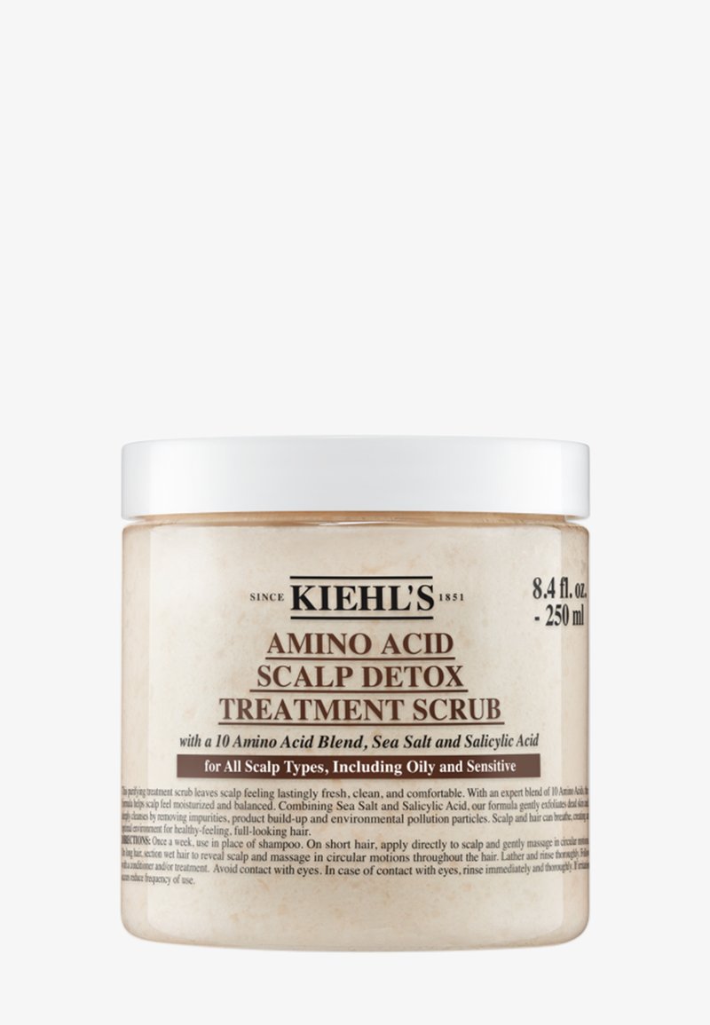 Barattolo bianco con coperchio avvitabile, contenente 250 ml di trattamento esfoliante per cuoio capelluto. L'etichetta presenta testo nero su sfondo beige, che dettaglia gli ingredienti.