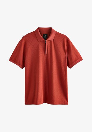 Red short-sleeve polo shirt with a diamond pattern, zip collar, and soft texture. Displays even color with a relaxed fit.