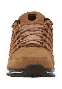 Hnědá semišová sportovní obuv s texturovaným svrškem, zdobená složitým šněrováním a polstrovanou podrážkou, zvýrazněná černou gumovou podrážkou.