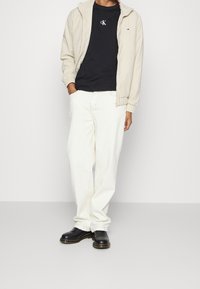 Tommy Jeans Tunn jacka - sand