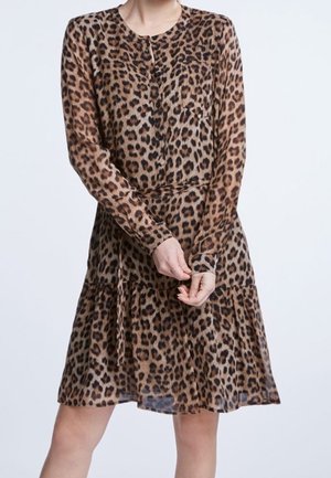 Woman wearing a long-sleeve, knee-length leopard print dress with a round neckline, buttoned front, and slightly gathered skirt.