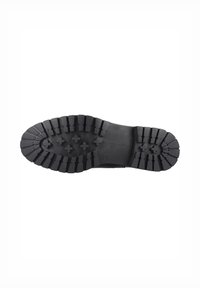 Suela de zapato de goma negra con profundos patrones de perfil y surcos para tracción. Presenta patrones en cruz adicionales para estabilidad y agarre.