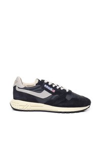 Sneaker navy e beige con mix di suede e pelle, colletto imbottito e suola crema testurizzata con accenti geometrici.