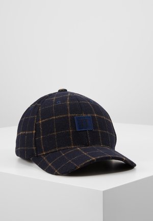 Marineblå ternet baseballkasket med brune gitterlinjer, der har et lille blåt stofmærke med to lodrette sorte linjer på frontpanelet.