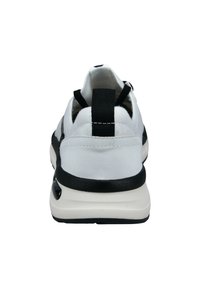 White sneaker with a black sole and accents. Features a textured rear pull tab and elastic design for easy wear. Smooth material overall.