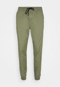 Olivgröna joggers med elastisk midja, svart dragsko, tapered ben och elastiska muddar.