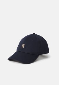 Navy blue baseball cap with a curved brim, six panels, and a gold logo on the front. Made of fabric with a smooth texture.