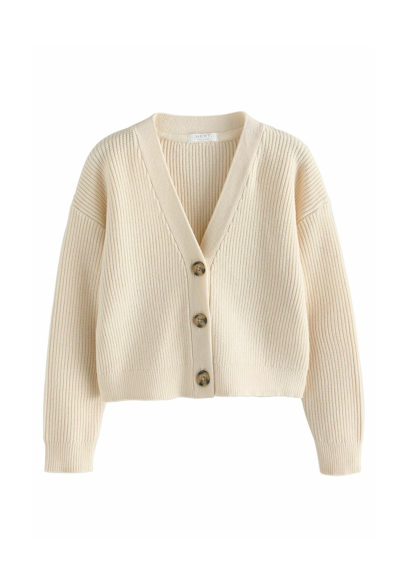 Gilet côtelé crème avec un col en V, présentant quatre boutons marron sur le devant et des coutures d'épaule tombantes ; texture douce et coupe courte.