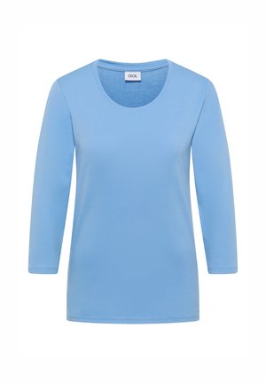Vaaleansininen pitkähihainen naisten paita pyöreällä pääntiellä, valmistettu sileästä kankaasta, jossa kauluksessa "CECIL"-merkintä.