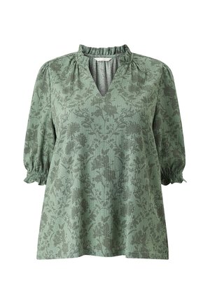 Groene top met bloemenpatroon, een V-hals en een geraffineerde halslijn. Heeft puffed mouwen met elastische manchetten en een gestructureerde stof.