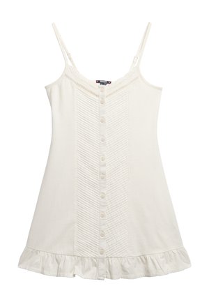 Vestido sin mangas color crema con botones en la parte frontal, panel texturizado y dobladillo con volantes; hecho de una tela suave con delicados detalles de encaje.
