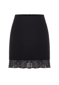 Mini-jupe noire, coupe droite avec un volant plissé en tissu transparent blanc à pois à l'ourlet.
