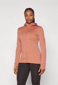 Hoodie leve, com fecho zip, na cor rosa velho, apresentando colarinho alto, mangas longas e buracos para os polegares. Tecido suave e elástico com costuras mínimas.