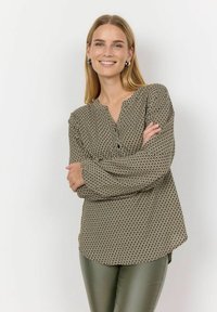 Long-sleeve blouse with a green and beige geometric pattern, V-neckline, and button detail at the front. Soft fabric with a relaxed fit.