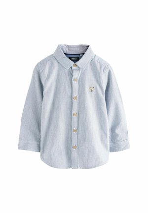Chemise à manches longues pour tout-petit, bleu clair texturée, avec col, boutons en bois sur le devant et petite broderie de visage d'ours sur la poitrine gauche.