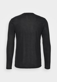 Long-sleeve black shirt made of soft fabric, featuring a crew neck, fitted shape, and smooth texture; no visible logos or patterns.