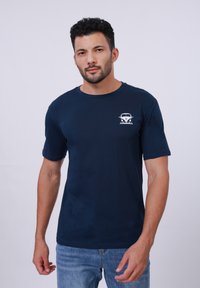 Navy blue cotton t-shirt with short sleeves, round neckline, and a white vintage car graphic on the left chest area.
