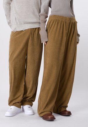 UNISEX - Tracksuit bottoms - brown