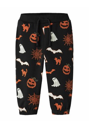 Pantalon noir pour enfants avec des imprimés sur le thème d'Halloween, incluant des citrouilles orange, des chauves-souris, des chats noirs, des fantômes blancs, des toiles d'araignée et des araignées.