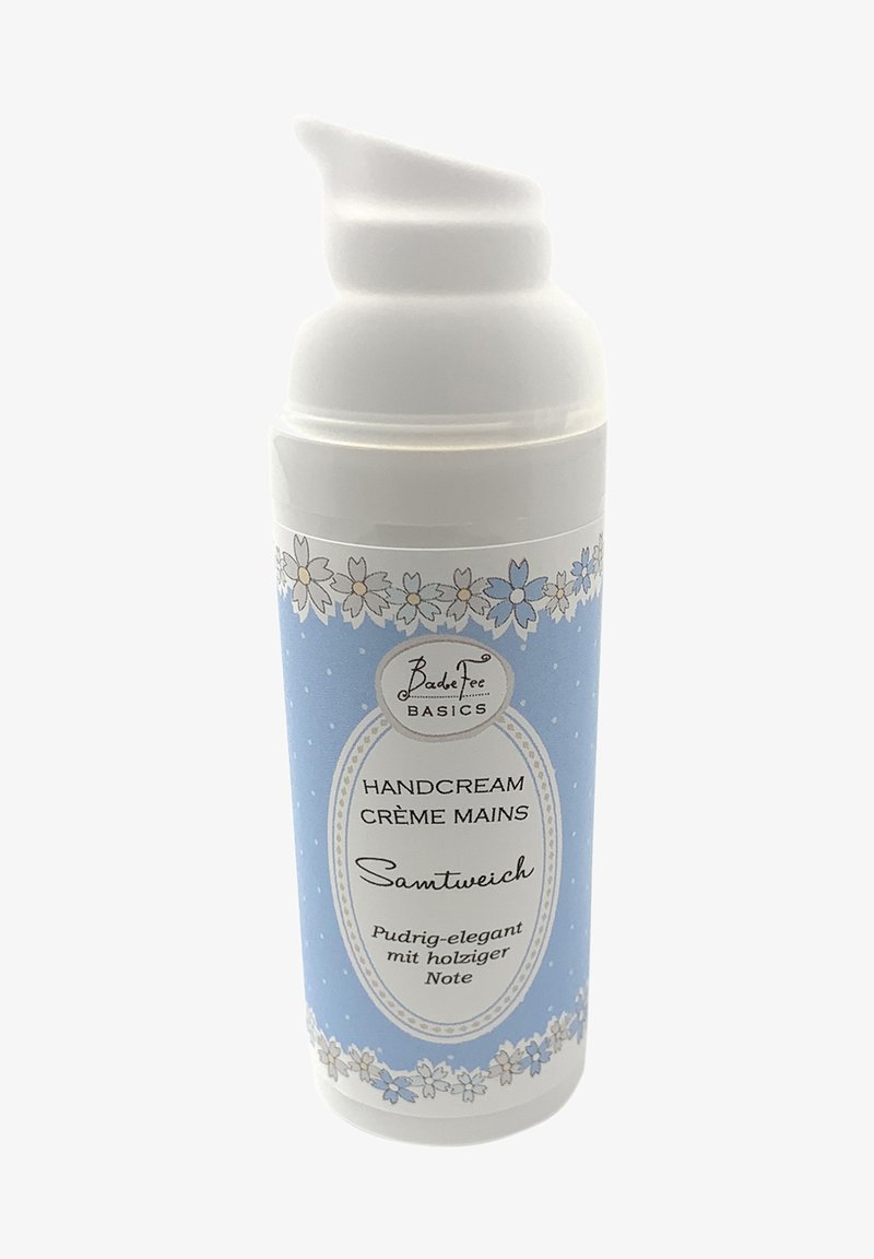 White pump bottle for hand cream with blue floral design. Features a raised label, blue background, and white accents.