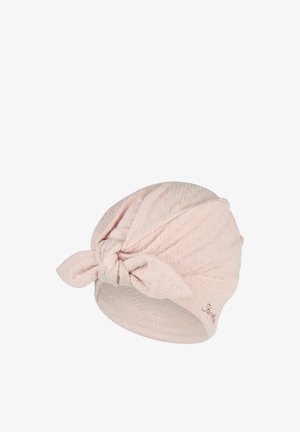 Light pink textured fabric turban hat with a front knot and small embroidered detail on one side.