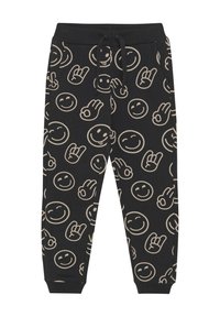 Zwarte katoenen sweatpants met een tan kleurige glimlachende gezicht en handgebaar patroon. Beschikt over een elastische tailleband en een verstelbare trekkoord.