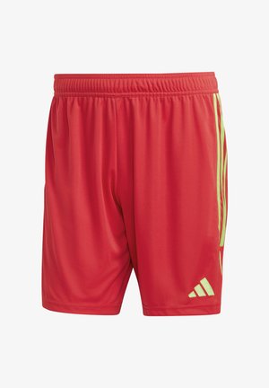 Red athletic shorts made of lightweight material. Features an elastic waistband and contrasting green side stripes with a logo.