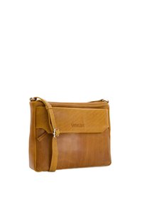 Leather crossbody bag in tan, featuring a smooth texture, a flap closure, and an adjustable strap. Marked with "VENEZIA" logo.