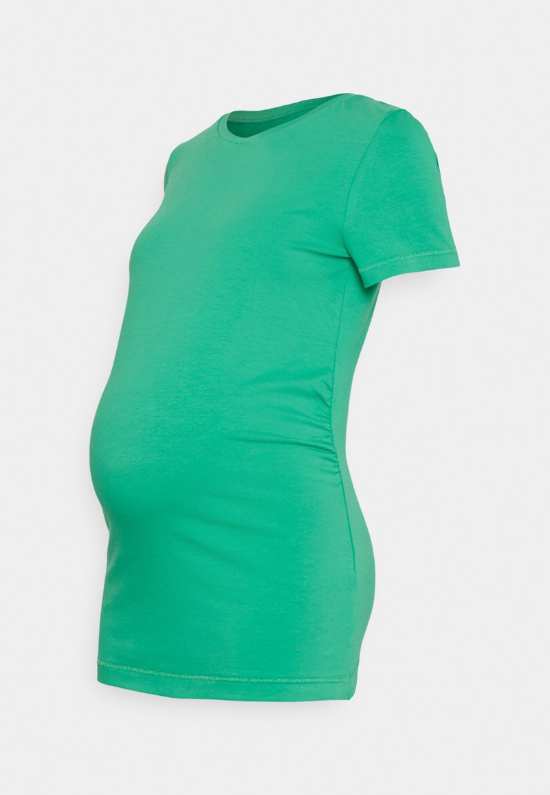 T-shirt de maternidade verde, mangas curtas, decote redondo, design ajustado com franzidos laterais para acomodar uma barriga em crescimento. Textura de tecido suave.