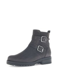Bottes noires à chevilles en cuir lisse, dotées de deux boucles argentées, d'un bout arrondi, d'une semelle en caoutchouc texturée et d'un talon court et robuste.