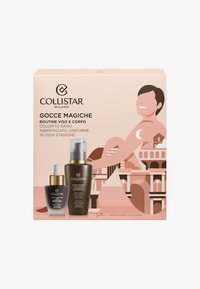 Collistar Gocce Magiche-set med två bruna glasflaskor. En har en pipett och den andra har en pump. Ljust rosa förpackningsdesign.