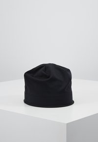 Sort beanie-hue lavet af blødt, strækbart stof. Har en glat tekstur med en samlet top og et stramt bånd i bunden.