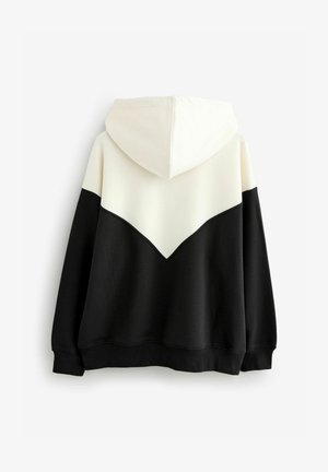 Kapucinum sweatshirt, millel chevrondisain, pool kreem ja pool must. Valmistatud pehmest kangast, millel ribikätised ja äär.