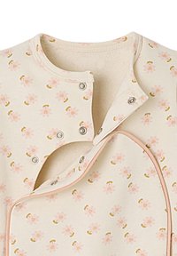 Floral-patterned soft fabric garment featuring pink flowers and gold accents. Snap closures at the neckline and soft pink trim.