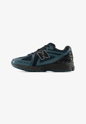Black and teal athletic shoes with mesh upper, reinforced heel, and textured sole. Features a prominent 'N' logo and lace closure system.