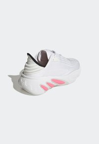 White athletic shoe with textured upper, black heel accent, and pink detailing on the sole. Features a rounded toe and lace-up design.