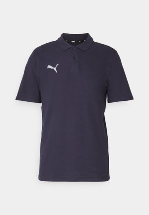 Navy blå polo skjorte laget av bomull med krage med to knapper, korte ermer, og en hvit Puma-logo på venstre bryst.