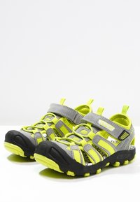 Sport sandals featuring a gray upper with bright yellow accents, secure Velcro straps, and a durable black rubber sole.