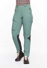 Hellgrüne Wanderhosen mit schwarzen Akzenten, ausgestattet mit Reißverschlusstaschen, slim fit, dehnbarem Material und verstärkten Kniebereichen für Strapazierfähigkeit.