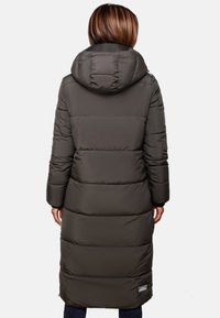 Long, dark gray puffer coat with a hood, featuring a quilted design, vertical seams, and a logo patch at the hem. Smooth texture.