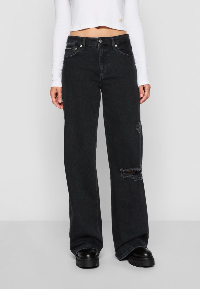 Black wide-leg jeans with distressed detailing, five pockets, belt loops, and a button closure, made from denim fabric.