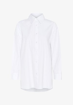 Balta garām piedurknēm krekls ar klasisku apkakli, priekšējo pogu aizdari un taisnu griezumu; izgatavots no gludas auduma ar tīru apdari.