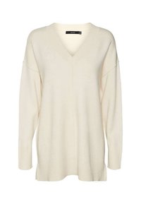 Pull en crème avec col en V et manches longues, fabriqué en tissu doux. Présente une coupe décontractée et des poignets côtelés, avec une couture verticale au centre devant.