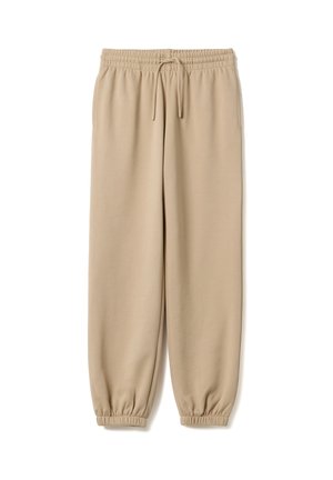 Beige joggingbroek met elastische tailleband en boorden, trekkoord en zijzakken, plat gelegd op een witte achtergrond.