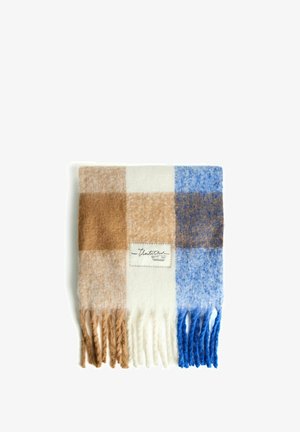 Coperta a quadri nei toni di marrone, crema e blu. Realizzata in tessuto morbido con bordi frangiati. Presenta un'etichetta cucita sul davanti.