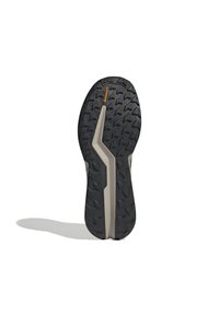 Svart gummisko sula med spårmönster för grepp, med en beige mellansula och "Continental"-logotyp i orange.