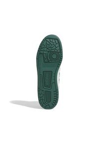 Suola di sneaker con fondo in gomma verde testurizzato, caratterizzata da un battistrada a motivo per la presa e un design del tallone arrotondato.