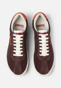 Bordowe sneakersy z białymi sznurówkami, wykonane z zamszu i płótna, o zaokrąglonym nosku oraz kontrastującymi brązowymi akcentami na pięcie. Nazwa marki widoczna wewnątrz.