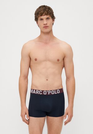 Donkerblauwe katoenen boxershorts met een brede bordeauxrode tailleband waarop "MARC O'POLO" in contrasterende tekst staat. Fitted design en een gladde textuur.